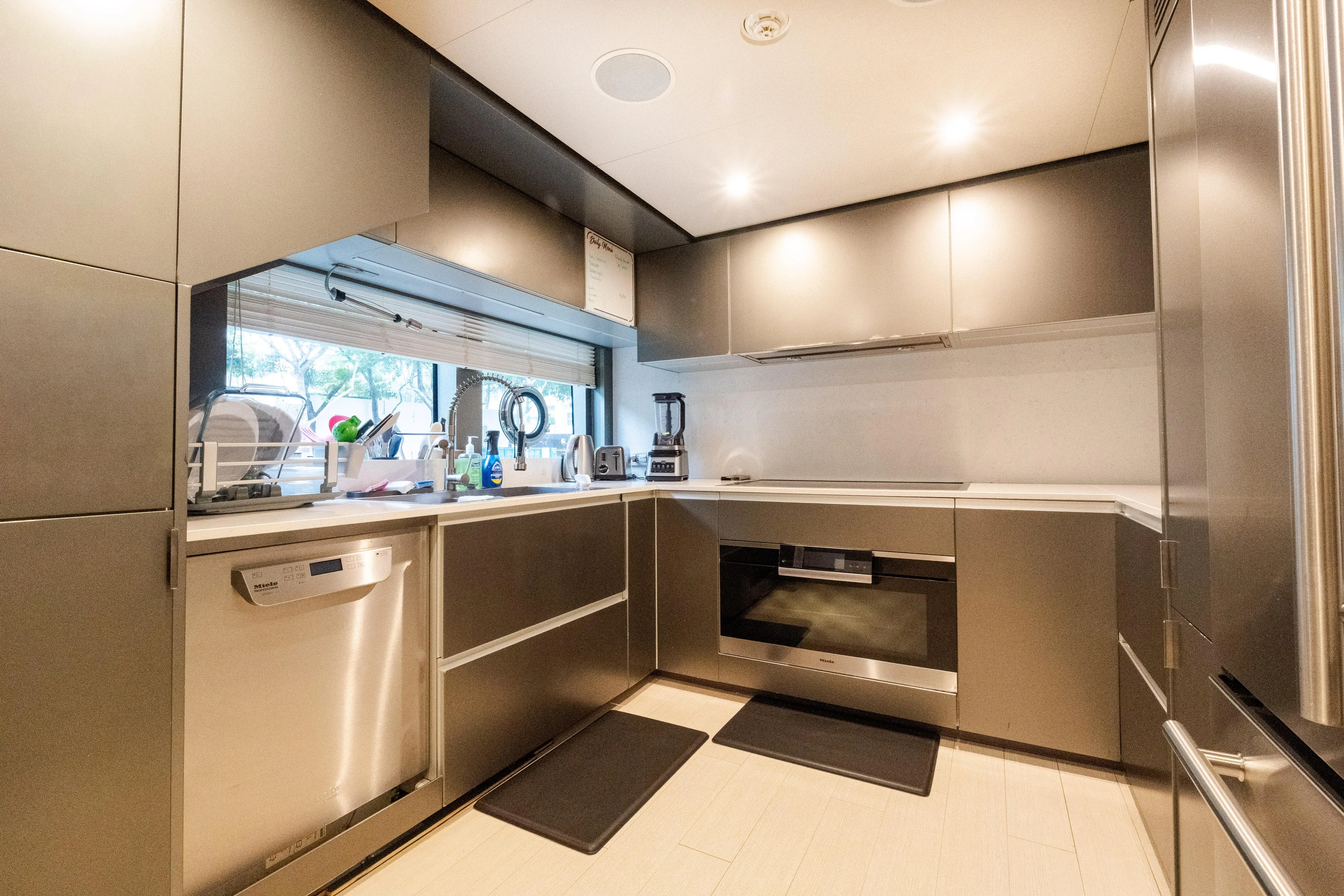 Amity Yacht Photos Pics Modern kitchen interior on 2018 Custom Line Navetta 33 yacht, featuring sleek cabinetry and appliances.