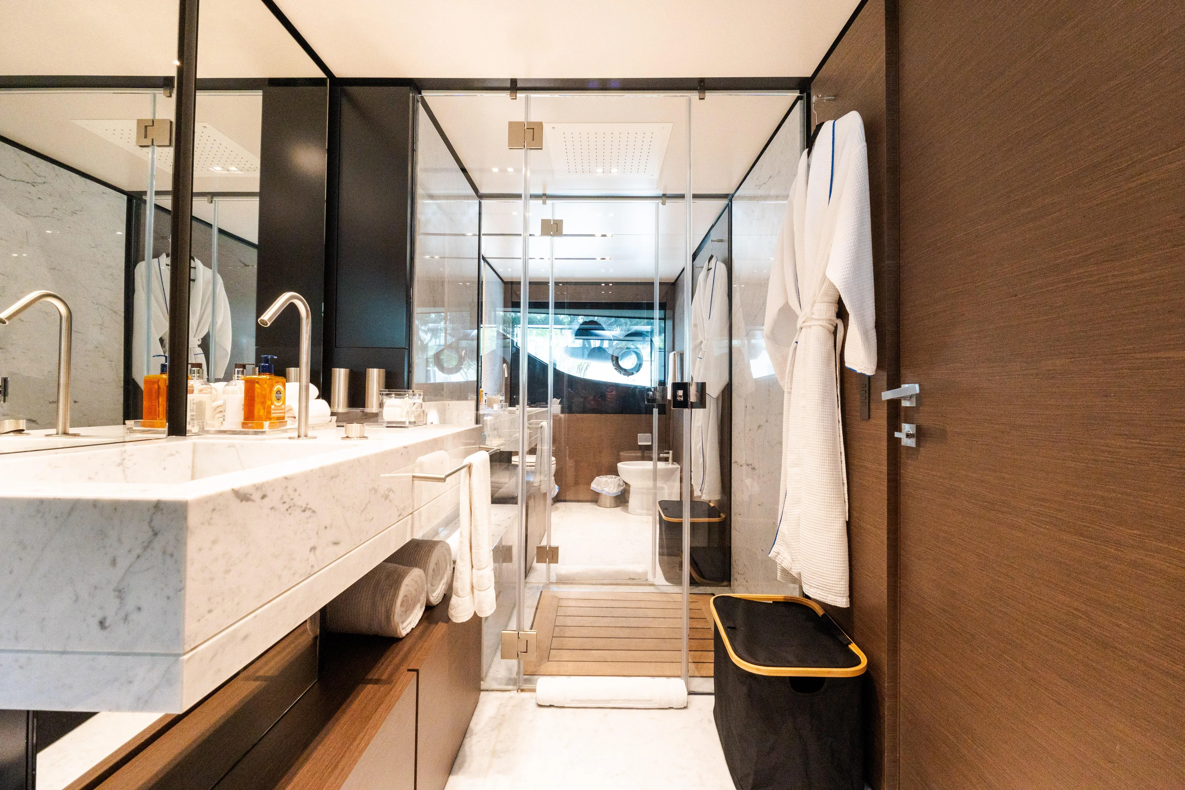 Amity Yacht Photos Pics Luxurious bathroom on 2018 Custom Line Navetta 33 yacht, featuring marble sink and glass shower.