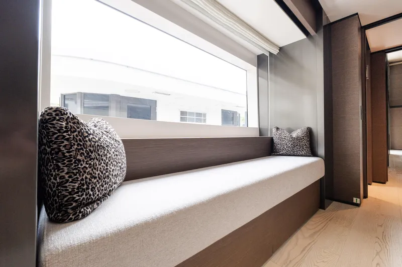 Amity Yacht Photos Pics Luxurious interior of 2018 Custom Line Navetta 33 yacht with elegant seating and leopard print cushions.