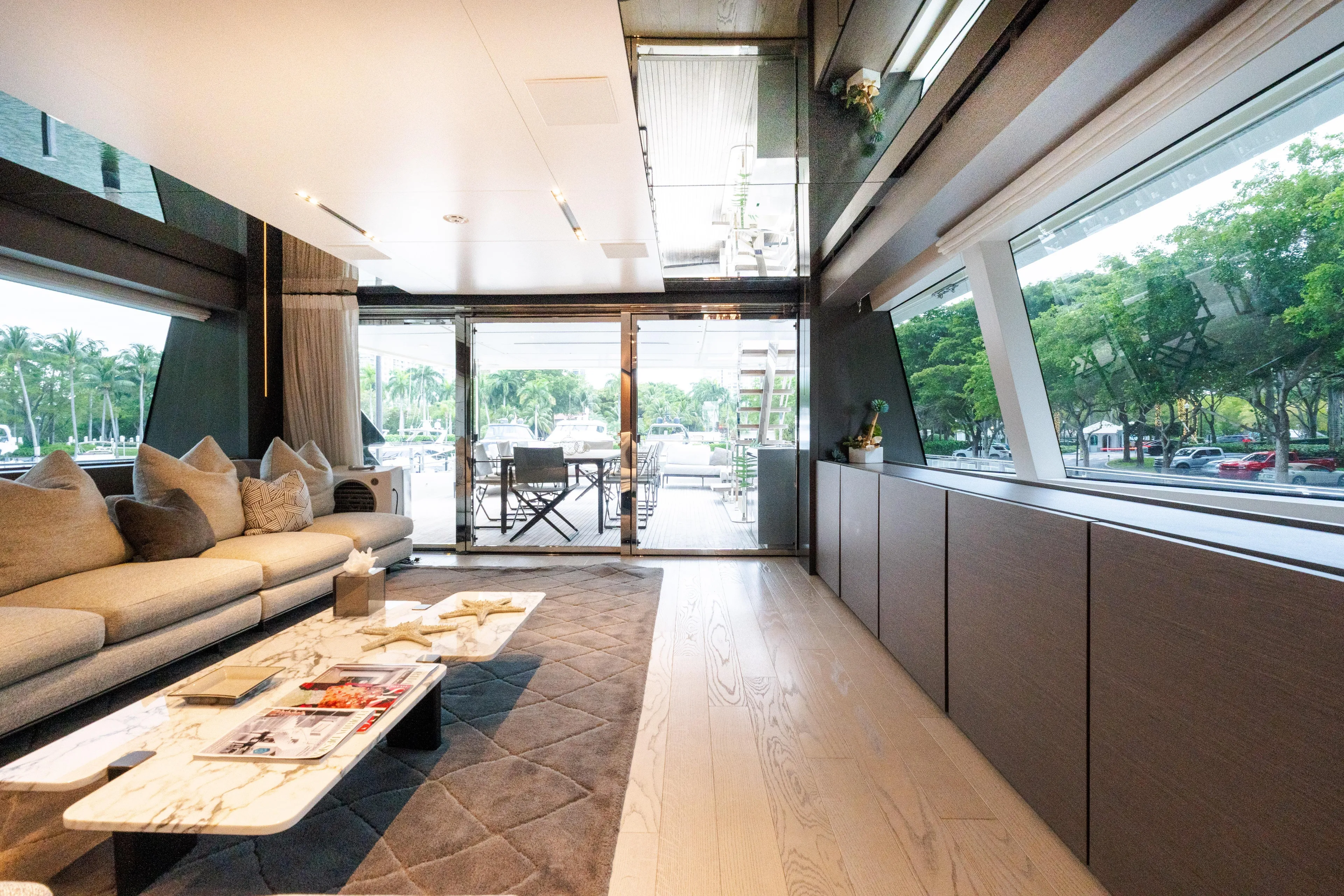 Amity Yacht Photos Pics Luxurious interior of 2018 Custom Line Navetta 33 yacht with elegant furnishings and large windows.