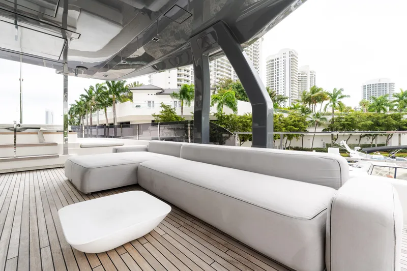 Amity Yacht Photos Pics Luxurious 2018 Custom Line Navetta 33 yacht deck with modern seating and cityscape view.