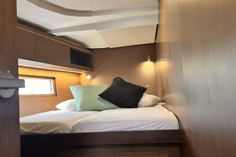  Yacht Photos Pics Luxurious cabin interior of 2023 Beneteau Oceanis 51.1 yacht with cozy bedding.