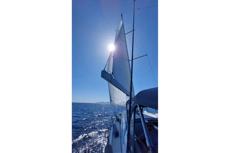  Yacht Photos Pics Sailing on a 2023 Beneteau Oceanis 51.1 yacht under clear blue skies.