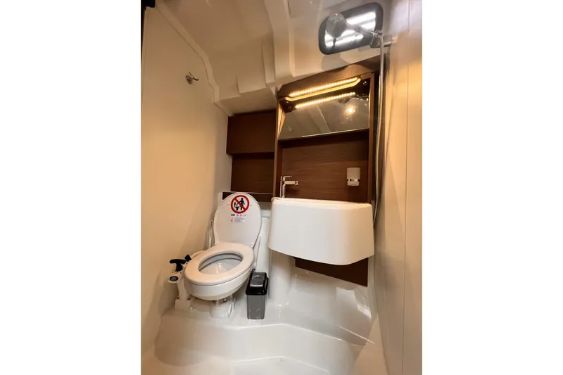  Yacht Photos Pics Modern bathroom in 2023 Beneteau Oceanis 51.1 yacht with toilet and sink.