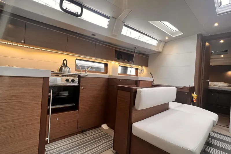  Yacht Photos Pics Luxurious interior of 2023 Beneteau Oceanis 51.1 yacht with modern kitchen and seating area.