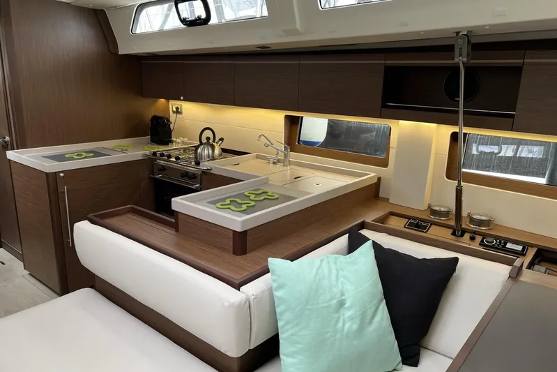  Yacht Photos Pics Luxurious interior of 2023 Beneteau Oceanis 51.1 yacht with modern kitchen and seating area.