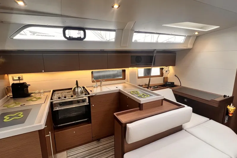  Yacht Photos Pics Modern kitchen interior of 2023 Beneteau Oceanis 51.1 yacht, featuring sleek design and appliances.