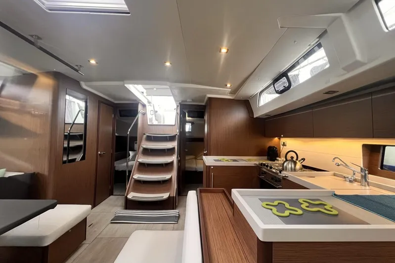  Yacht Photos Pics Interior of 2023 Beneteau Oceanis 51.1 yacht, featuring modern kitchen and elegant wood finishes.