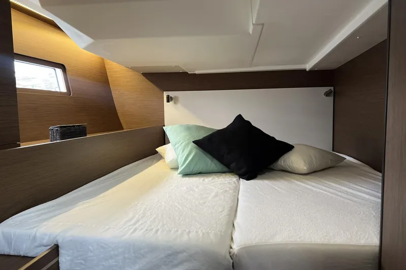  Yacht Photos Pics Cozy cabin interior of 2023 Beneteau Oceanis 51.1 yacht with comfortable bedding.