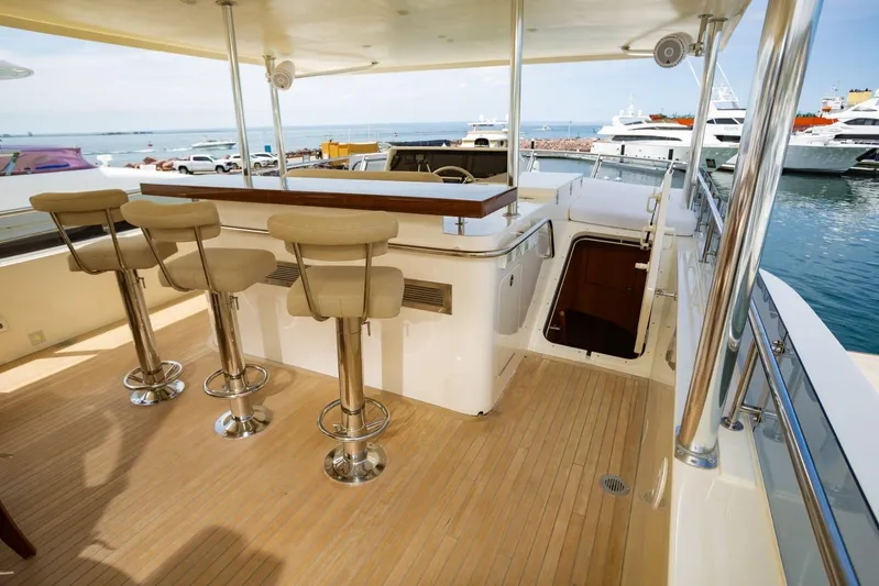 Alegre Yacht Photos Pics Luxurious 2004 Symbol M.S Super 88 Motoryacht deck with bar stools and ocean view.