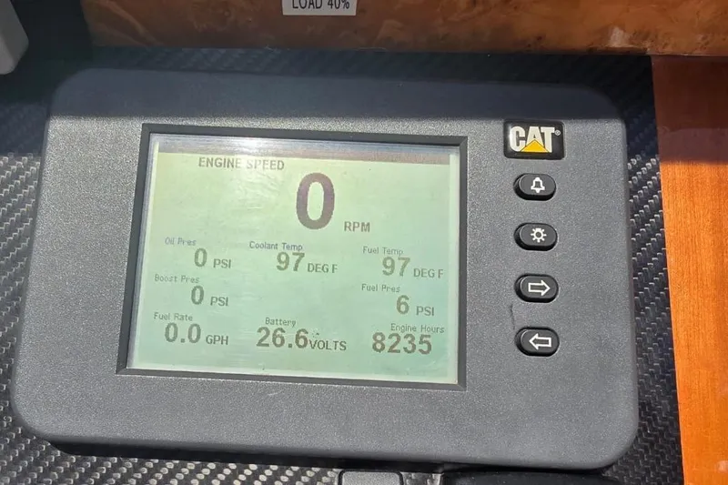 Alegre Yacht Photos Pics CAT engine monitor displaying 0 RPM, 97°F coolant, 26.6 volts, on a 2004 Symbol M.S Super 88 Motoryacht.