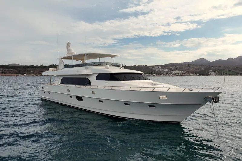 Alegre Yacht Photos Pics Luxury 2004 Symbol M.S Super 88 Motoryacht on serene waters, scenic coastal backdrop.