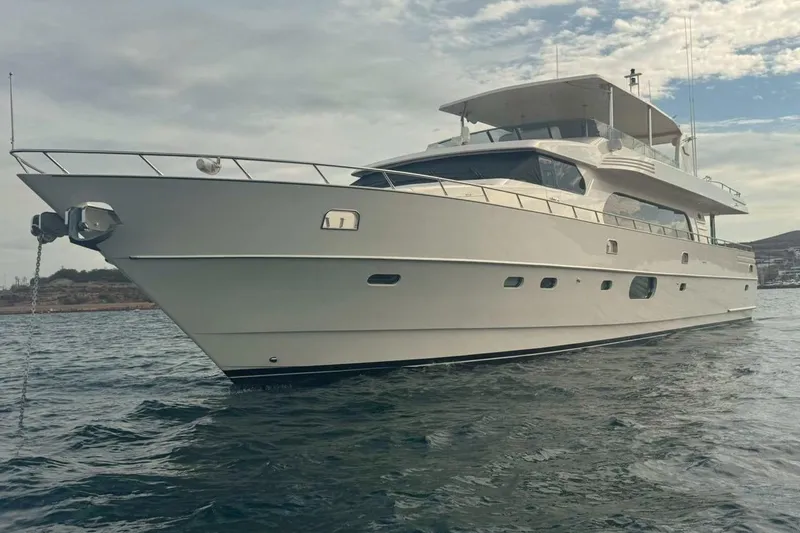 Alegre Yacht Photos Pics Luxurious 2004 Symbol M.S Super 88 Motoryacht on calm waters under a cloudy sky.