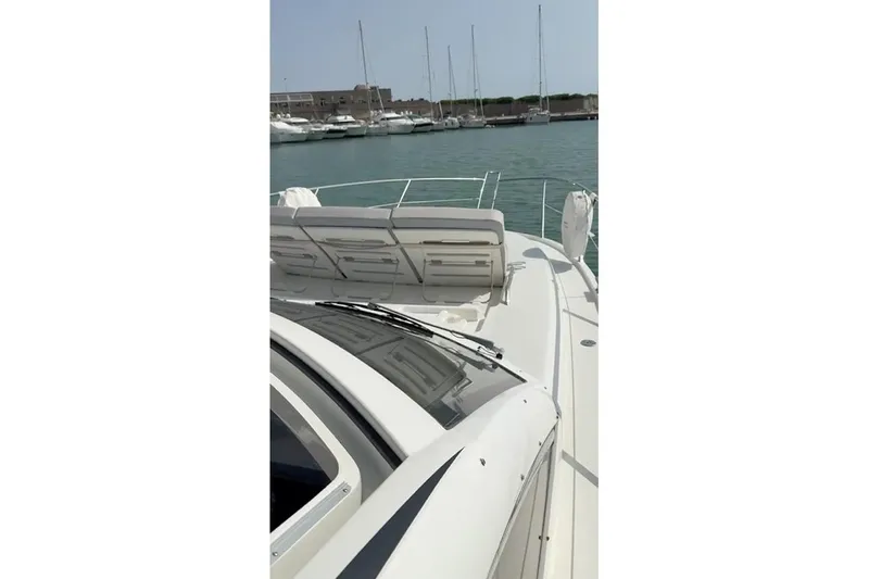  Yacht Photos Pics 2010 Sunseeker Portofino 48 yacht docked in marina, showcasing sleek deck design.