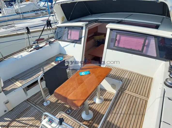  Yacht Photos Pics 2011 Beneteau Sense 50 yacht cockpit with wooden table and seating area.