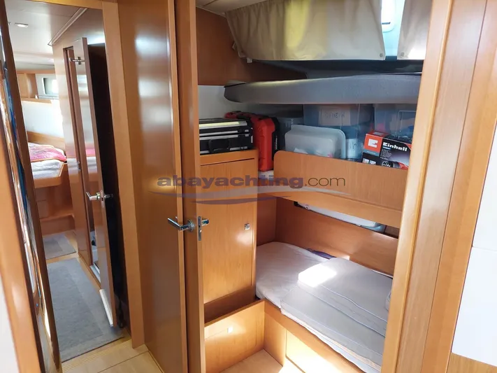  Yacht Photos Pics Interior of 2011 Beneteau Sense 50 yacht, featuring cozy wooden cabin with storage.