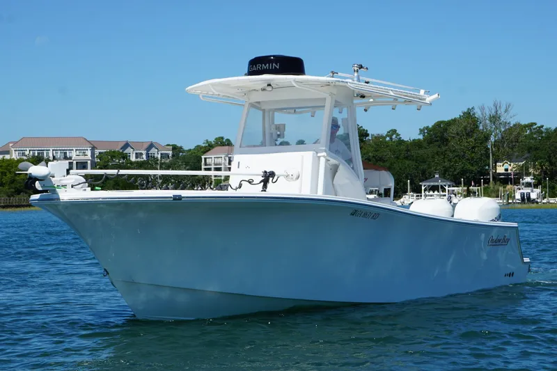  Yacht Photos Pics 2016 Onslow Bay 27 XS boat on water, clear sky, residential background.