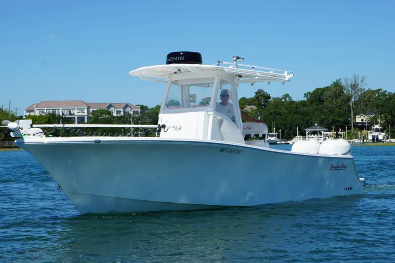  Yacht Photos Pics 2016 Onslow Bay 27 XS boat cruising on a sunny day near waterfront homes.