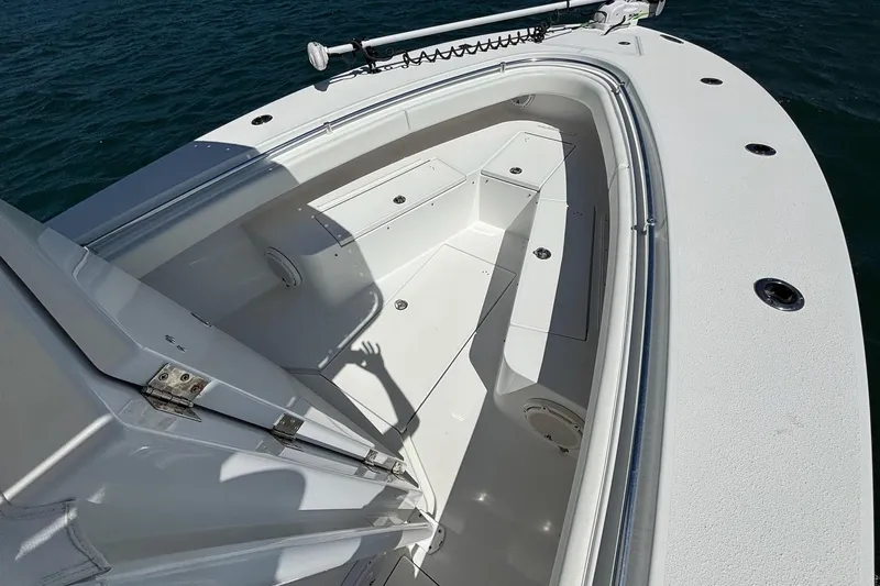  Yacht Photos Pics 2016 Onslow Bay 27 XS boat interior with seating and storage, on calm water.