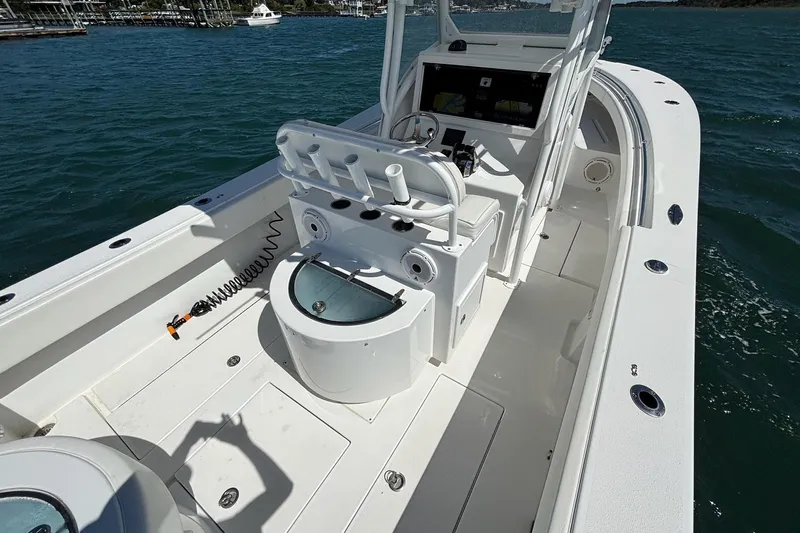 Yacht Photos Pics 2016 Onslow Bay 27 XS boat interior with helm and seating, on calm water.