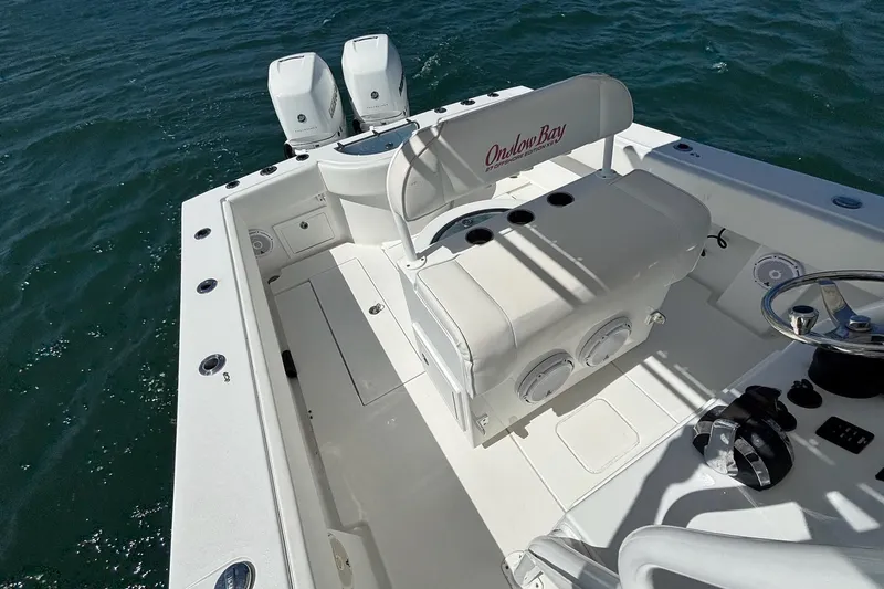  Yacht Photos Pics 2016 Onslow Bay 27 XS boat interior with dual engines on open water.