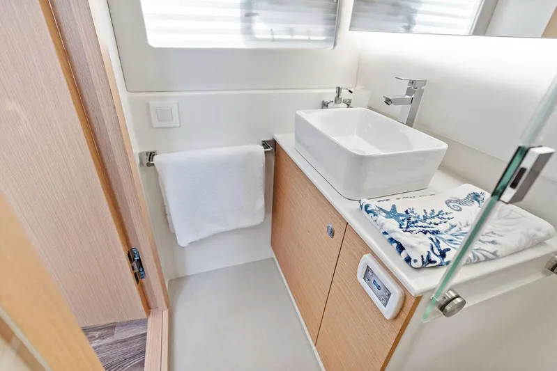  Yacht Photos Pics Modern bathroom in 2025 Makai M37 yacht with sleek sink and wooden cabinetry.