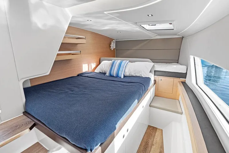  Yacht Photos Pics Luxurious cabin interior of 2025 Makai M37 yacht with cozy bedding and modern design.