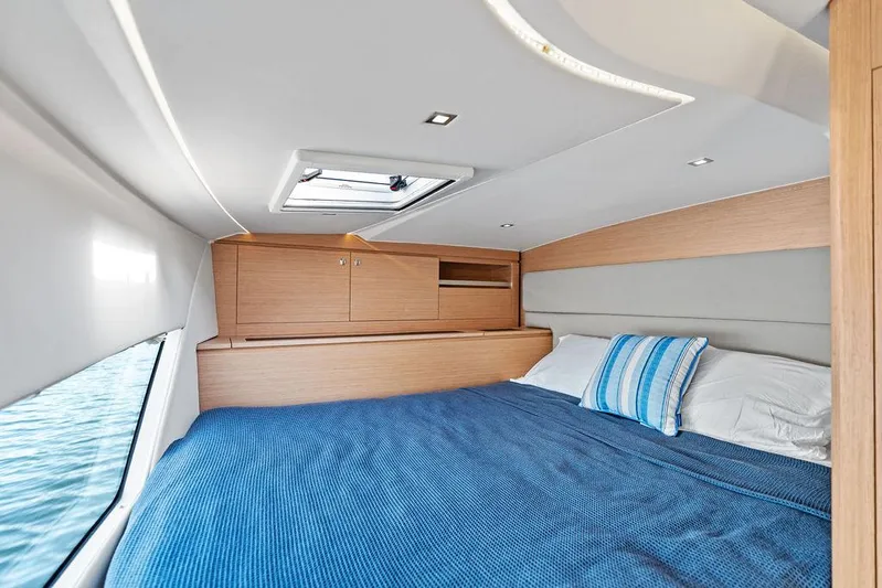  Yacht Photos Pics Luxurious cabin interior of 2025 Makai M37 yacht with cozy bedding and modern design.