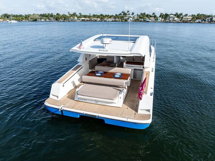  Yacht Photos Pics 2025 Makai M37 yacht on calm water, featuring spacious deck and seating area.