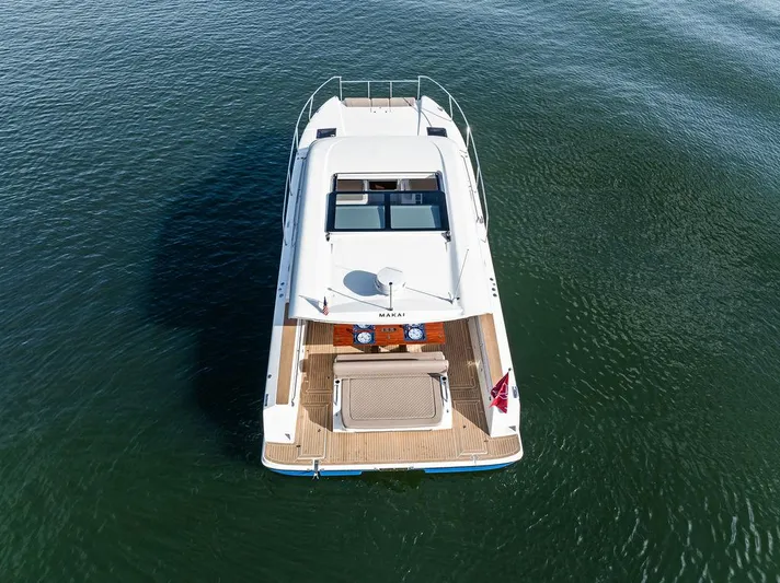  Yacht Photos Pics 2025 Makai M37 yacht on calm water, aerial view showcasing deck and sleek design.