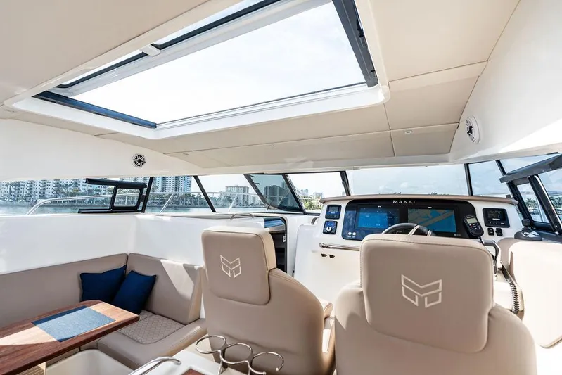  Yacht Photos Pics Interior of 2025 Makai M37 yacht with modern helm and seating area.
