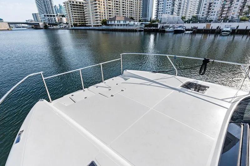  Yacht Photos Pics Deck view of 2025 Makai M37 yacht overlooking urban waterfront.