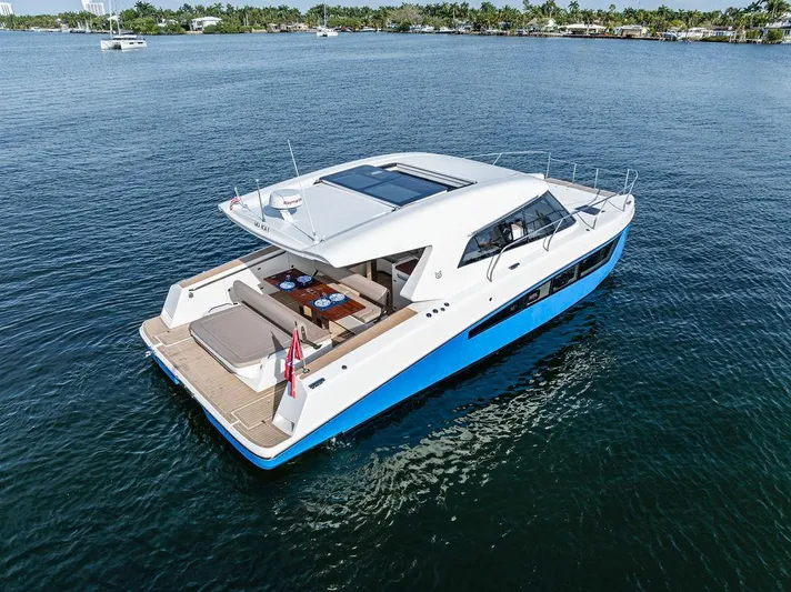  Yacht Photos Pics 2025 Makai M37 yacht cruising on calm waters, featuring sleek design and spacious deck.