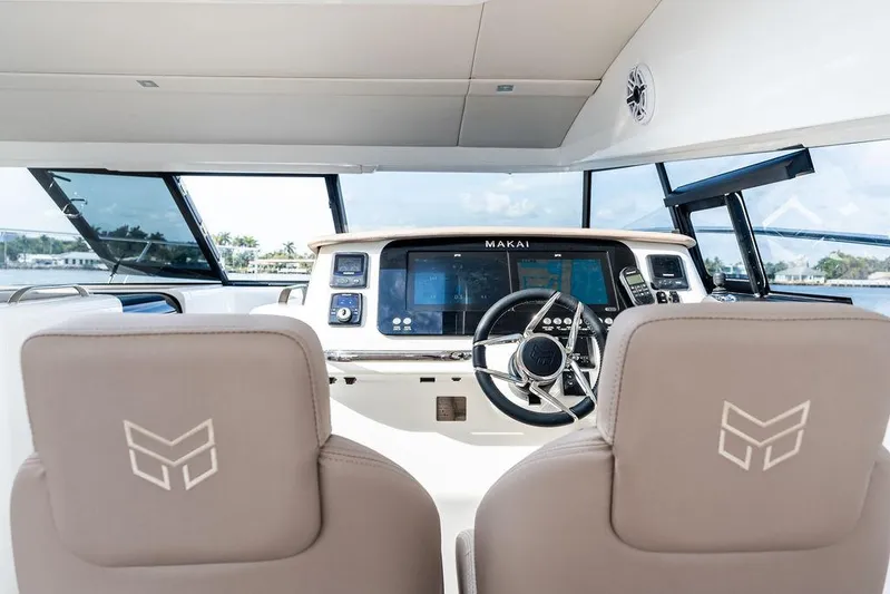  Yacht Photos Pics 2025 Makai M37 yacht cockpit with modern steering and navigation controls.