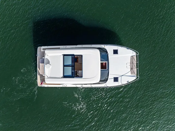  Yacht Photos Pics Aerial view of 2025 Makai M37 yacht cruising on green water.
