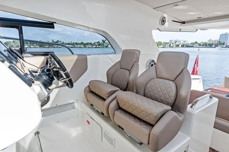  Yacht Photos Pics Luxury interior of 2025 Makai M37 yacht with plush seating and modern helm.