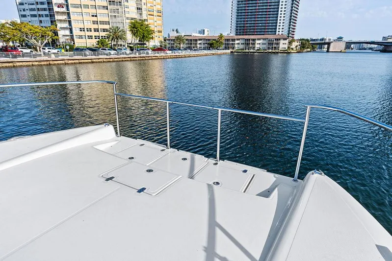  Yacht Photos Pics Deck view of 2025 Makai M37 yacht overlooking urban waterfront and buildings.
