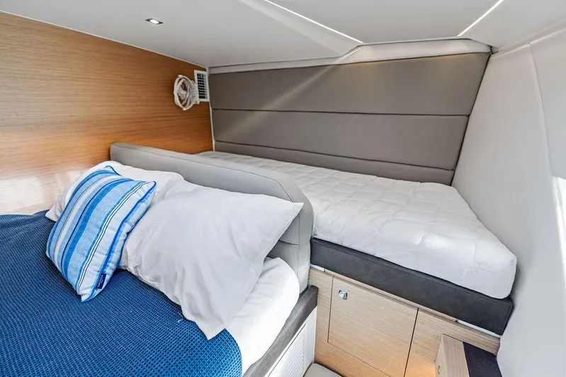  Yacht Photos Pics Interior cabin of 2025 Makai M37 yacht with modern bedding and wood accents.