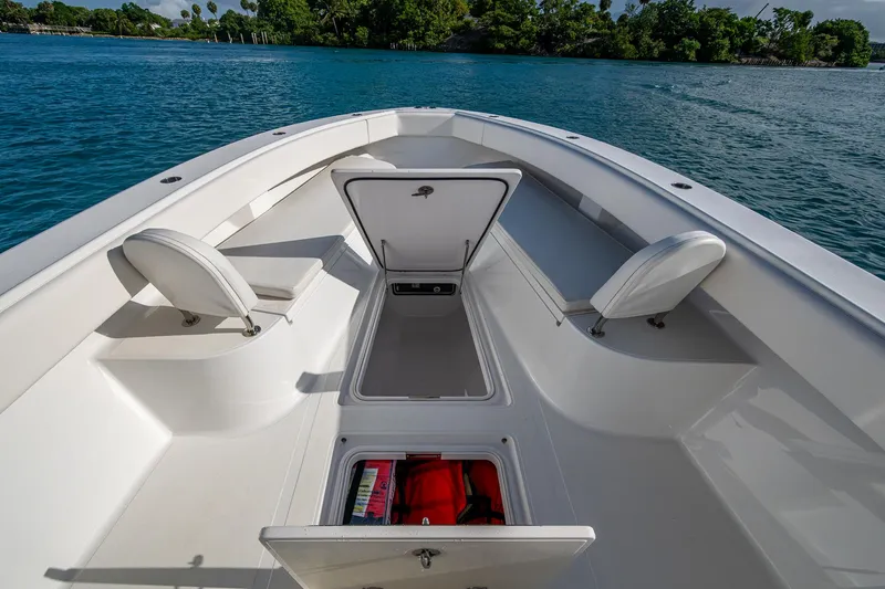 Irish Exit Yacht Photos Pics 2016 Bahama boat with Mercury V10 engines, open storage compartments, and seating, on calm blue water.