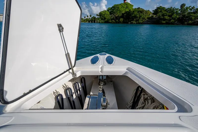 Irish Exit Yacht Photos Pics 2016 Bahama boat with Mercury V10 engines, open storage compartment, scenic water and greenery background.