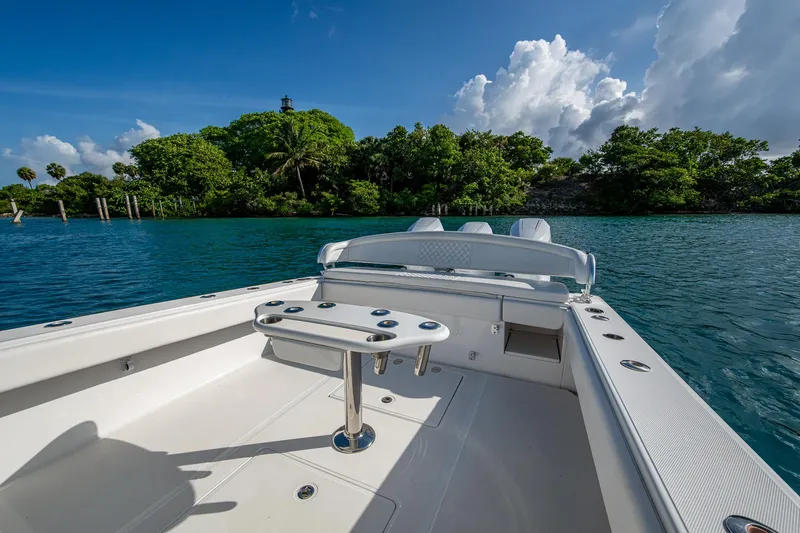 Irish Exit Yacht Photos Pics 2016 Bahama boat with Mercury V10 engines, docked in tropical waters, lush greenery in background.