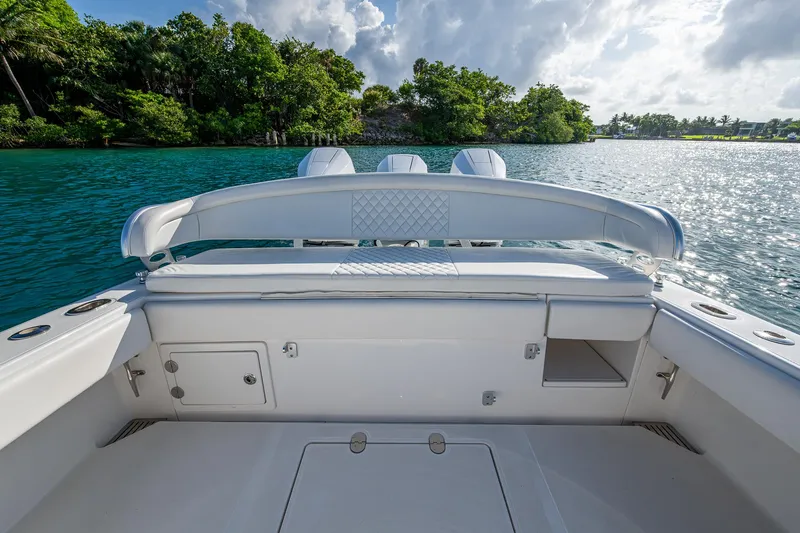 Irish Exit Yacht Photos Pics 2016 Bahama boat with Mercury V10 engines, docked on a serene, tropical waterway.