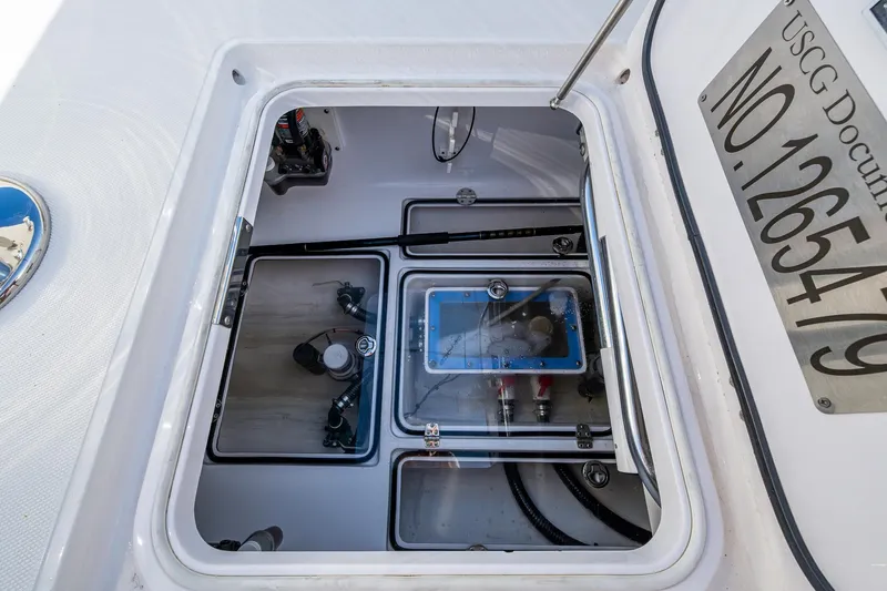 Irish Exit Yacht Photos Pics 2016 Bahama boat compartment with Mercury V10 engines, showing internal components and USCG documentation.