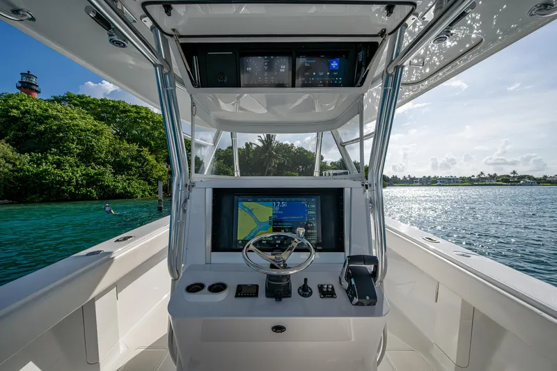 Irish Exit Yacht Photos Pics 2016 Bahama boat cockpit with Mercury V10 engines, featuring advanced navigation system, on a sunny day.
