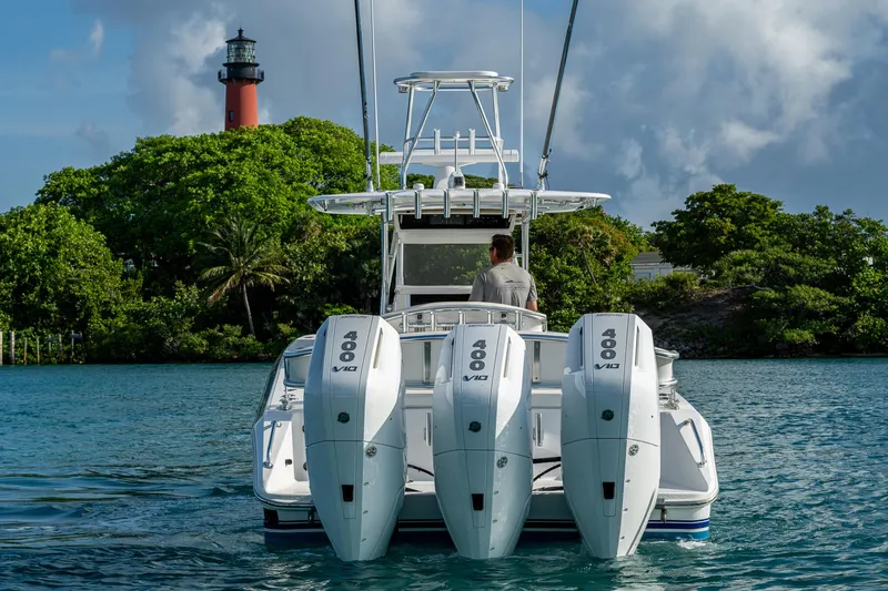 Irish Exit Yacht Photos Pics 2016 Bahama boat with Mercury V10 engines near a lighthouse on a sunny day.