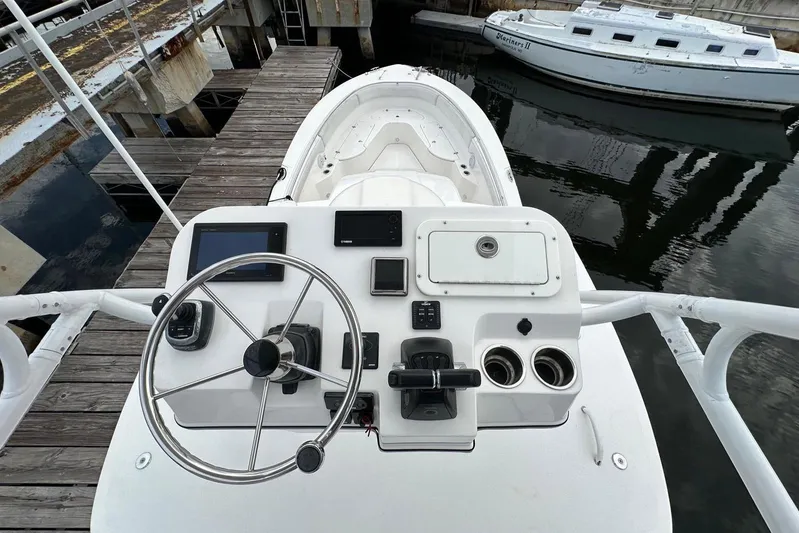  Yacht Photos Pics 2017 Edgewater 368CC boat helm with steering wheel and navigation controls at dock.