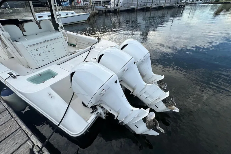  Yacht Photos Pics 2017 Edgewater 368CC boat with triple outboard engines docked at marina.