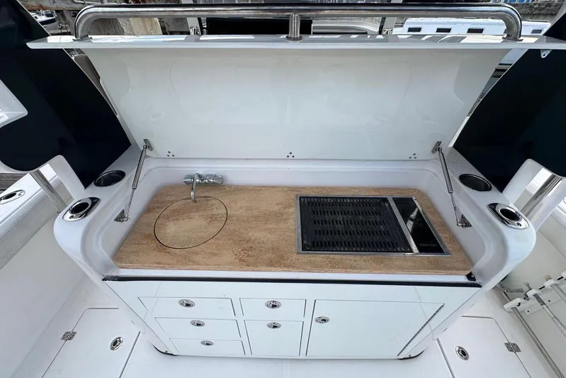  Yacht Photos Pics Outdoor kitchen on 2017 Edgewater 368CC boat with sink and grill.