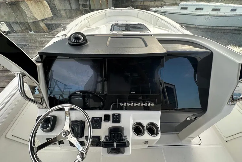  Yacht Photos Pics 2017 Edgewater 368CC boat helm with steering wheel, navigation screens, and controls.