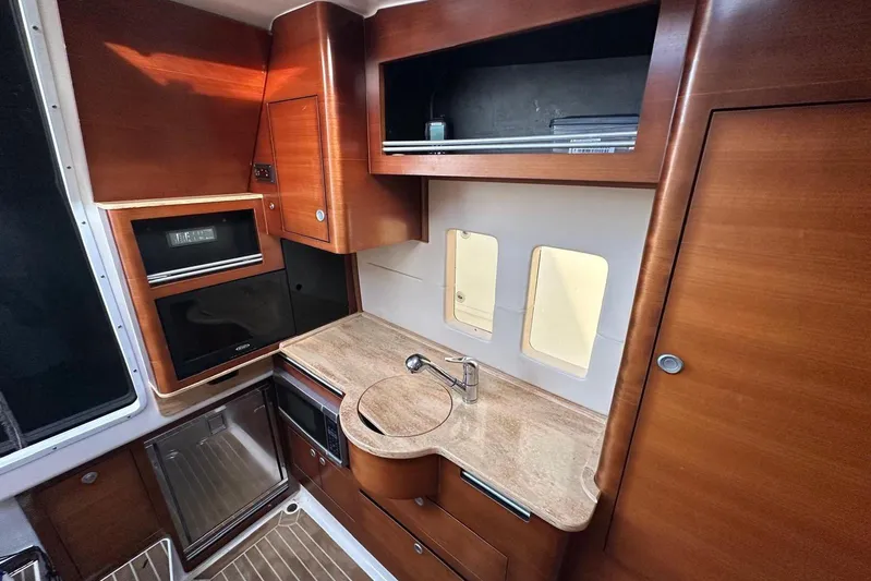  Yacht Photos Pics Luxurious 2017 Edgewater 368CC boat interior with modern kitchen amenities and wooden cabinetry.